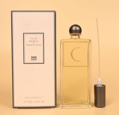 a close up of a bottle of perfume next to a box