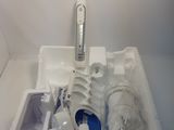 a white box with a toothbrush and other items in it