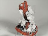 a small piece of rock with a lot of white crystals on it