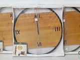 three clocks that are in the packaging on the table