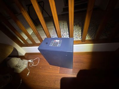a blue box sitting on the floor next to a chair