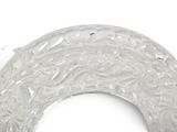 a close up of a plastic object on a white surface