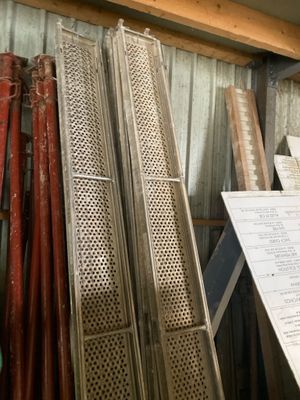 several pieces of metal are stacked on top of each other in a room