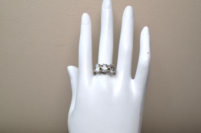 a white mannequin hand with a ring on it
