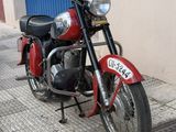 a red motorcycle parked on the side of the street