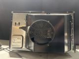 a silver microwave with a fan on top of it