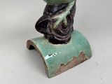 a statue of a woman sitting on top of a table