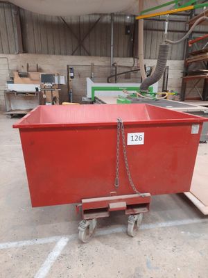 a red box with a chain attached to it in a warehouse