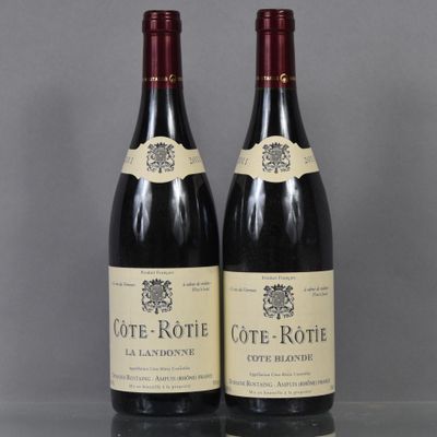 two bottles of wine sitting on top of a table