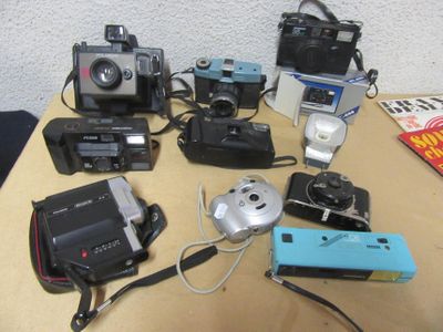 many different types of cameras sitting on a table