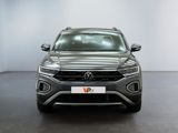 the front view of a silver volkswagen suv parked in a room