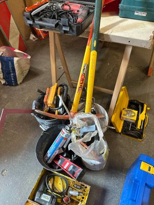a pile of tools sitting on the floor in a garage
