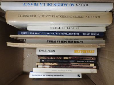 many books stacked on top of each other in a box