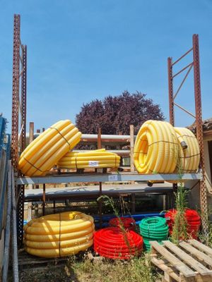 many different types of hoses stacked on a rack