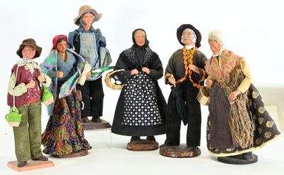 five figurines of people dressed in traditional clothing