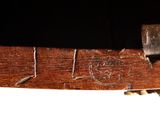 a close up of a piece of wood with a metal handle