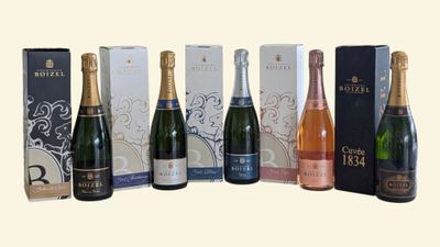 several bottles of wine are lined up in a row