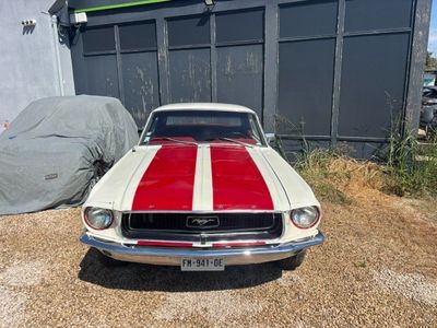 a red and white striped car parked in front of a building