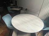 a table and chairs in a room with wood flooring