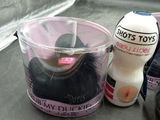 a plastic container with a brush and a bottle of lotion next to it