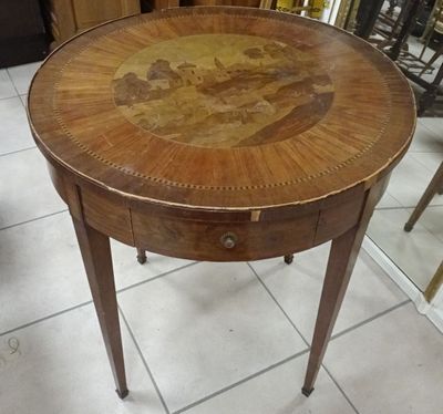a small table with a painting on the top of it