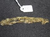 a close up of a gold chain with a tag on it
