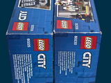 two boxes of legos sitting on top of each other