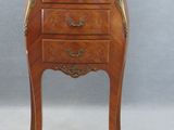 a small wooden table with a marble top on it