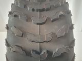 a close up of a motorcycle tire on a white surface