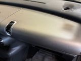 a dashboard of a car with a steering control