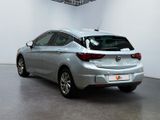 the back end of a silver car in a white room