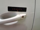 a sticker on the door handle of a white car