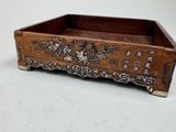 a small wooden box with a design on it