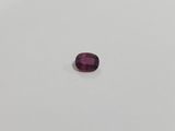 a purple oval shaped gems on a white surface