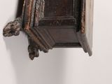 a wooden shelf with a clock on top of it