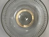 a clear glass bowl with a gold rim on a white table