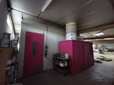 a room with a pink door and a pink cabinet in it