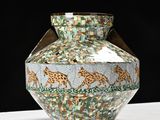 a vase that has giraffes on it on a table