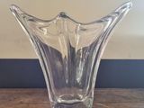 a glass vase that is sitting on a wooden table
