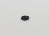 a green tourmaline gemstone on a white surface