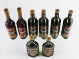 several bottles of liquor are lined up on a white surface