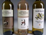 three bottles of wine sitting next to each other on a table