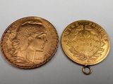 two gold coins, one of which is a woman and one of which is a man