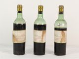 trois bouteilles de vin posées l'une à côté de l'autre sur une table