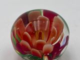 a glass bowl that has a flower inside of it