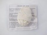 a white ball of yarn on a piece of paper