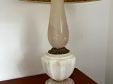 a lamp that is sitting on a table with a lamp shade on it