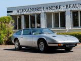 a silver sports car parked in front of a building