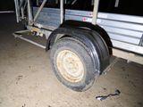 a truck that has a flat tire on the side of it