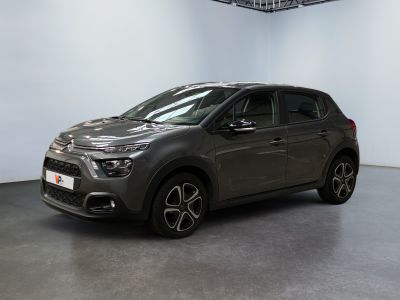a grey citrole is parked in a large room